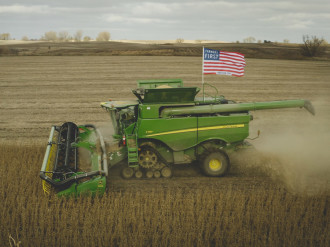 Image of combine with Farmers First flag