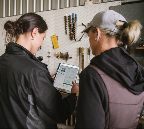farmer and fbn employee looking at tablet