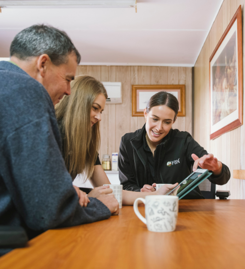 fbn employee and farmer at desk 500x550